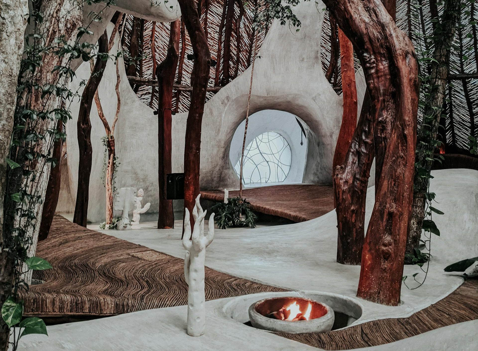 An artistic indoor space featuring natural wood beams and minimalist design elements.