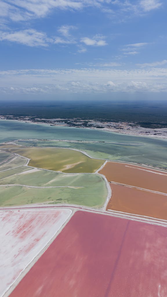 Stunning aerial shot of vibrant salt ponds in Las Coloradas, Yucatán, Mexico, showcasing nature's artistry.