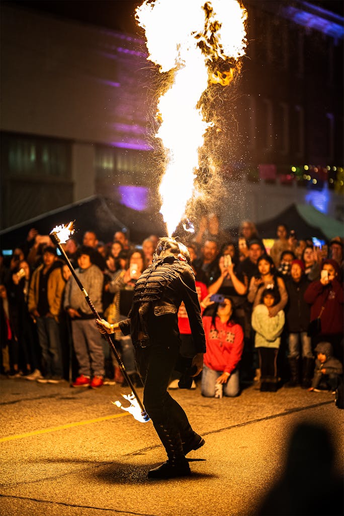 Dramatic fire performance captivates a street festival audience in Wichita Falls, Texas.